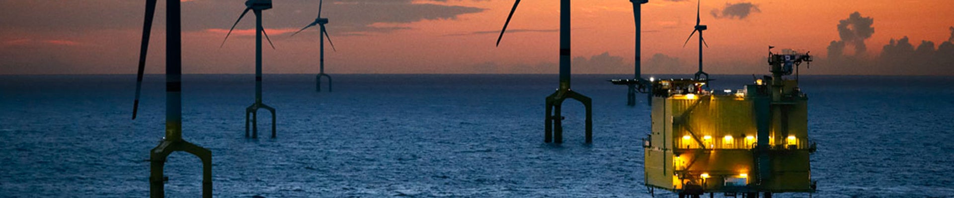 Offshore windmills in sunset